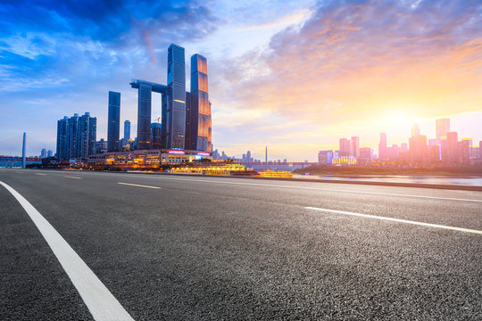 Empty asphalt road and city skyline with buildings in Chongqing at sunset,China. © ABCDstock