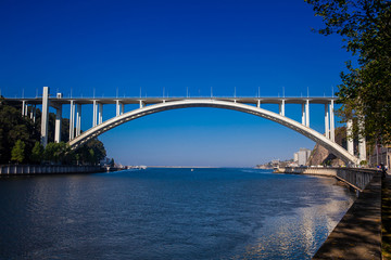 View of the Douro River mouth and the Arrabida Bridge in a beautiful early spring day at Porto City in Portugal