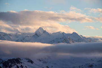 Fototapeta na wymiar Kitzsteinhorn Snowy mountains sunset landscape view dark mood weather clouds
