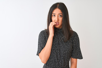 Young chinese woman wearing elegant t-shirt standing over isolated white background looking stressed and nervous with hands on mouth biting nails. Anxiety problem.