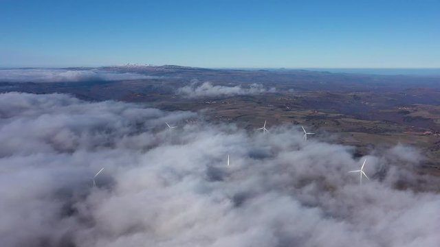 Panoramic view of wind turbines in clouds Massif Central mountains France Auvergne 