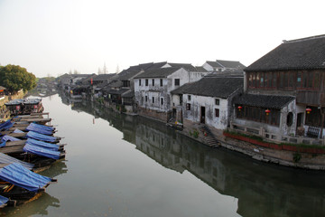 Fototapeta na wymiar Ancient houses and beautiful reflections by the water on the Jiangnan Canal in China