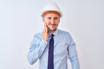 Young business man wearing contractor safety helmet over isolated background touching mouth with hand with painful expression because of toothache or dental illness on teeth. Dentist concept.