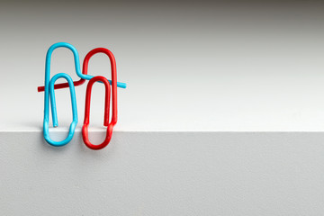 Paper clips in the form of a hugging couple in love for the concept of happy relationship