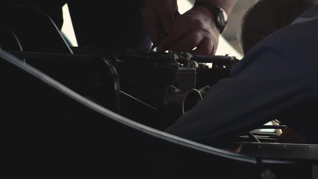 Mechanics working on a sports car.
