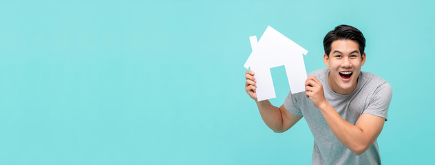 Happy young handsome Asian man holding paper home