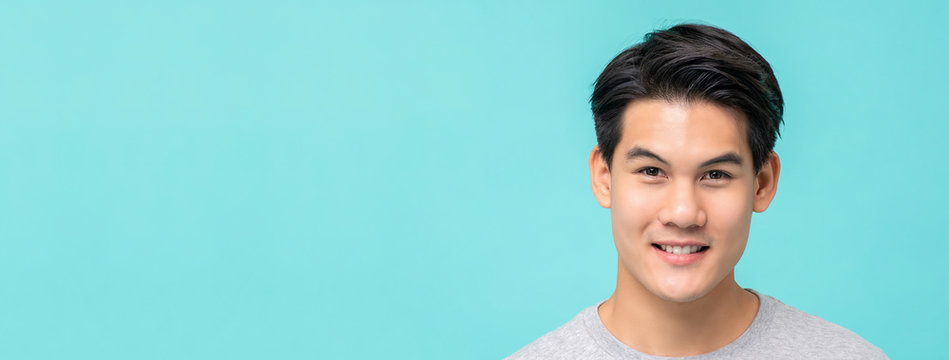 Smiling Young Handsome Asian Man Face On Light Blue Banner Background