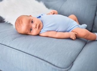 Adorable baby lying down on the sofa at home. Newborn relaxing and resting comfortable