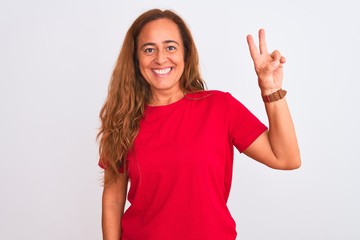 Middle age mature woman standing over white isolated background showing and pointing up with fingers number two while smiling confident and happy.