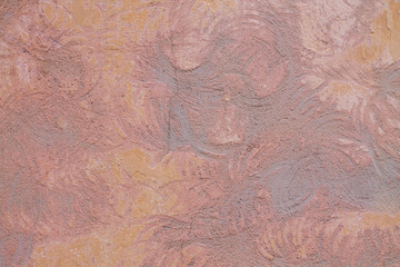 The texture of the pink wall. Paint and putty with circles on the wall.