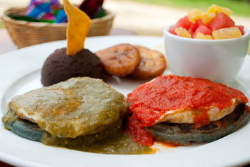  Dish served for breakfast in Guatemala, traditional and organic outdoors on wooden table, nutrition, calories and protein to start the day.