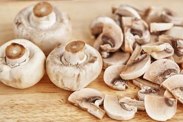 Champignons are on a wooden table. Close-up