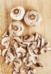 Champignons are on wooden table. View from above.