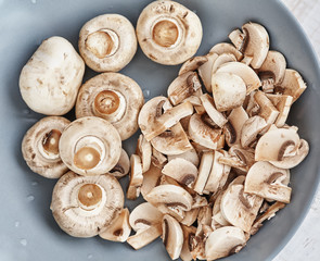 Champignons are on blue plate. View from above, close up