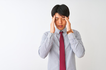 Chinese businessman wearing elegant tie standing over isolated white background with hand on headache because stress. Suffering migraine.