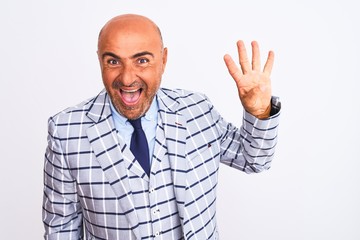 Middle age businessman wearing suit standing over isolated white background showing and pointing up with fingers number four while smiling confident and happy.