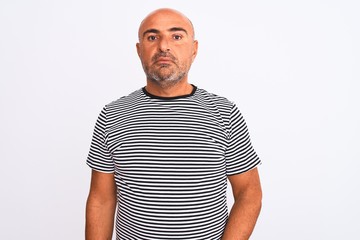 Middle age handsome man wearing striped navy t-shirt over isolated white background Relaxed with serious expression on face. Simple and natural looking at the camera.