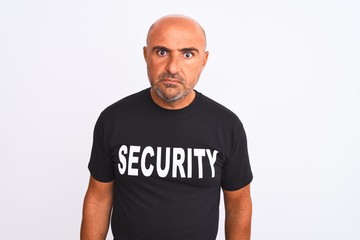 Middle age safeguard man wearing security uniform standing over isolated white background skeptic...