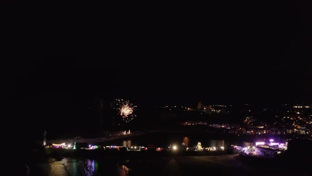 Fireworks over Whitby, a popular tourist destination on the Yorkshire Heritage Coast, UK. Static aerial footage of the Whitby Regatta fireworks display of 2019.