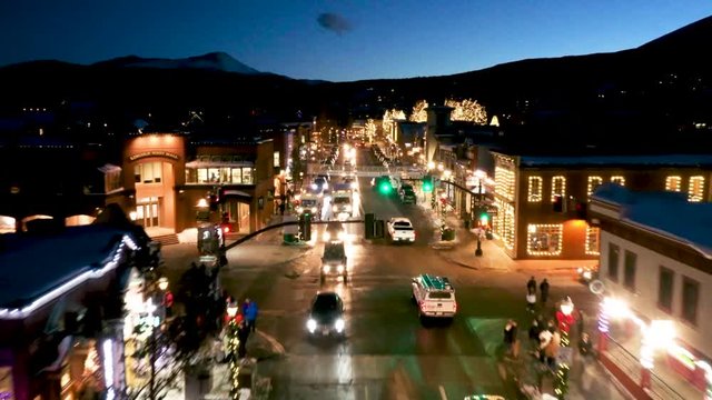 Aerial drone footage over Main Street in the ski town of Breckenridge, Colorado at night.