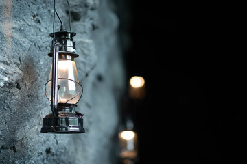 Oil lamp hanging on the cave stone wall