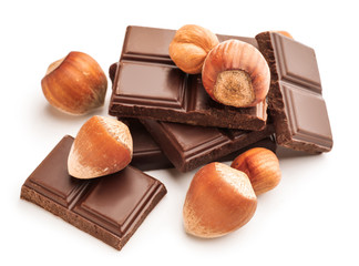 Tasty chocolate with hazelnuts on white background