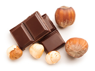 Tasty chocolate with hazelnuts on white background