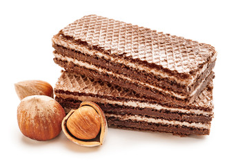 Tasty chocolate waffles with hazelnuts on white background