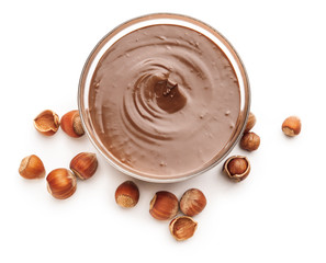 Tasty chocolate paste with hazelnuts on white background