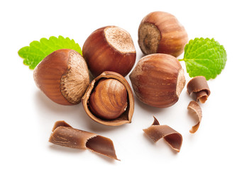 Tasty chocolate with hazelnuts on white background