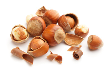 Tasty chocolate with hazelnuts on white background