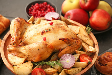 Tasty baked turkey with vegetables for Thanksgiving day on table