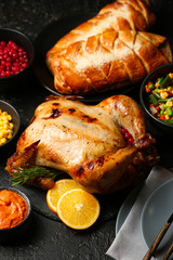 Tasty baked turkey and other dishes for Thanksgiving day on table