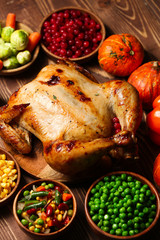 Tasty baked turkey and other dishes for Thanksgiving day on table