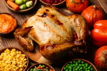 Tasty baked turkey and other dishes for Thanksgiving day on table
