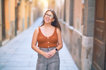 Young beautiful woman smiling happy and confident. Standing with smile on face at the town street