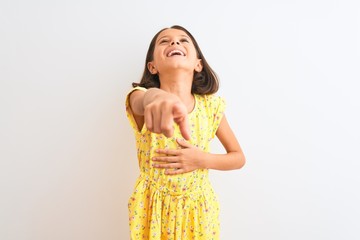 Young beautiful child girl wearing yellow floral dress standing over isolated white background...