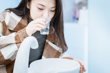 Young Asian female gargle in dental room