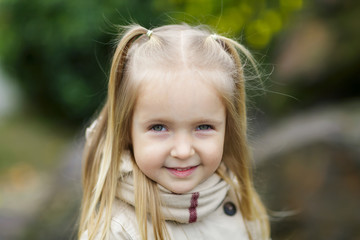 Portrait of beautiful little girl in the park