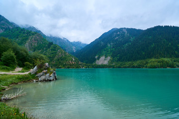 Fototapeta premium View of mountain lake Issyk. Almaty. Kazakhstan. The Lake Issyk also known as Issyk Lake is a lake in Kazakhstan fed by the Issyk River.