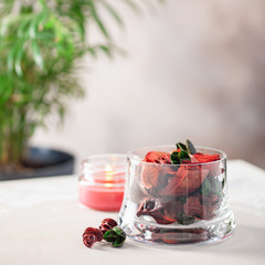 Dried flowers in a glass and candle. Flower flavor, home aromatherapy