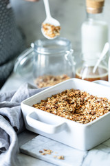 Cooking Homemade granola. Woman filling mason jar with homemade granola. Selective focus.