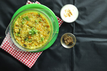 Famous Popular Indian Masala Dal Khichadi Or Khichadee Made Of Rice Lentils and Green Vegetables With Curd and Pickles