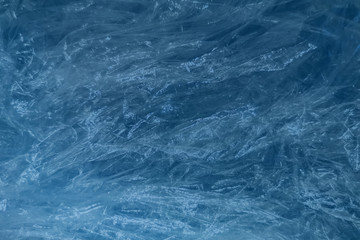Abstract background, texture of crumpled plastic film. Tinted in classic blue trendy color.
