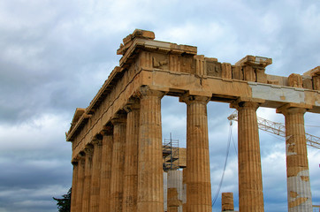 Close-up view of ruins of famous ancient Greek temple of Parthenon against cloudy sky. Famous touristic place and travel destination in Europe. Acropolis, Athens, Greece