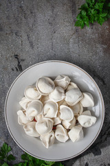 tortellini with filling (ravioli dumplings) menu concept. food background. top view. copy space