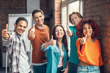 Students showing thumbs up while feeling good after studying