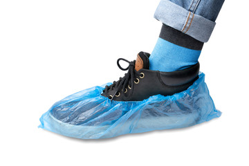 men's foot in Shoe covers. foot in sneakers and jeans