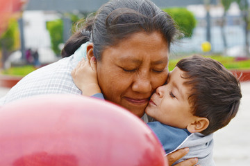 Tender portrait of indigenous South American woman with her little son.