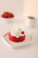 Raspberry muffins with cream on white background